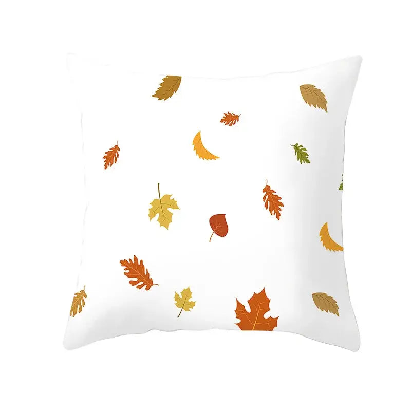 White throw pillow with plush fabric featuring a pattern of autumn maple leaves in orange yellow and brown for living room decor