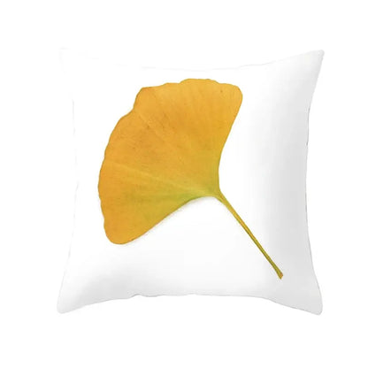 White throw pillow with golden-yellow ginkgo leaf print for botanical autumn maple leaves living room decor