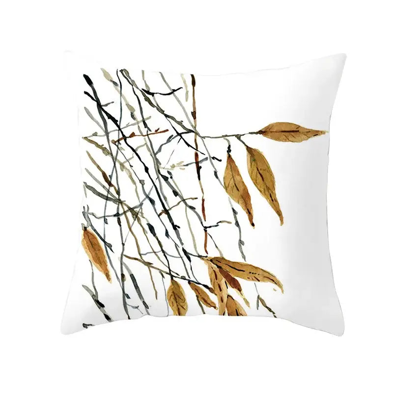 White throw pillow with watercolor autumn maple leaves design featuring slender branches and dried golden leaves