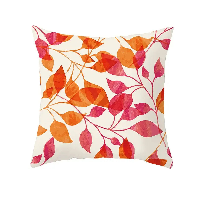 Square throw pillow with watercolor-style orange and pink autumn maple leaves on cream background for living room decor