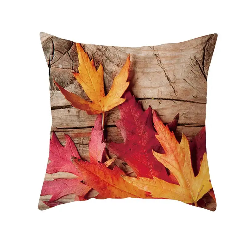 Square throw pillow featuring vibrant red and orange autumn maple leaves on a plush case for living room decor
