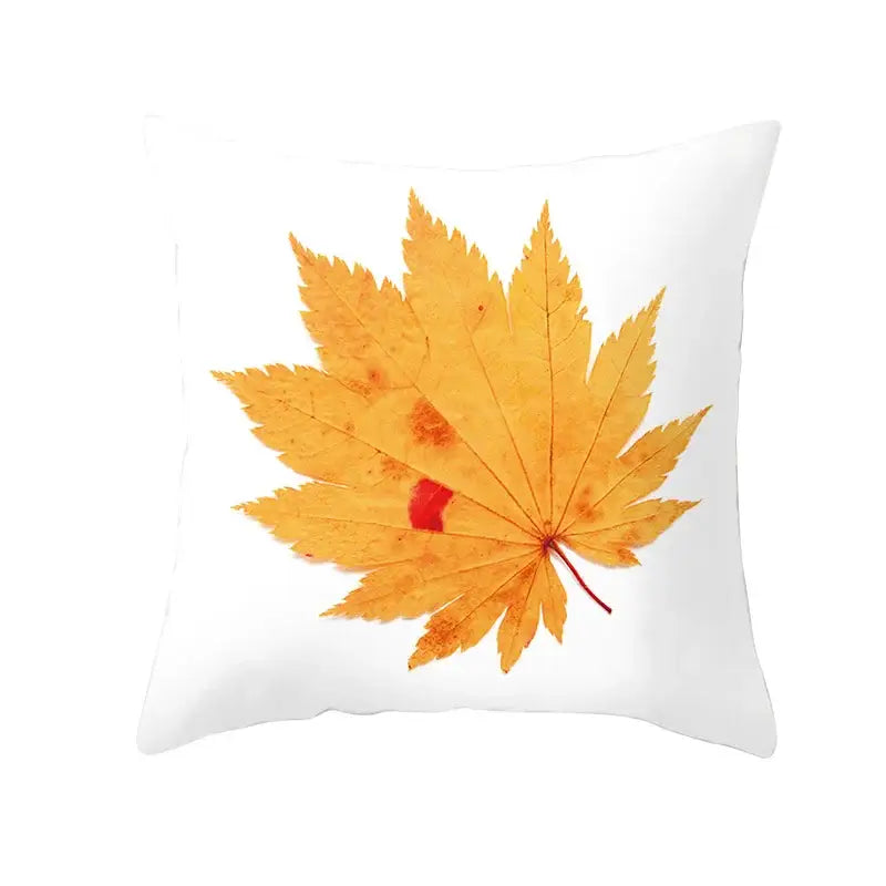 White throw pillow with detailed golden-yellow autumn maple leaves print for living room decor