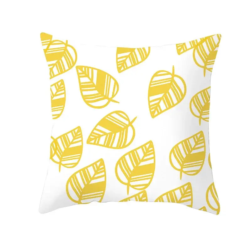 White throw pillow with yellow stylized autumn maple leaves and striped detailing for living room decor