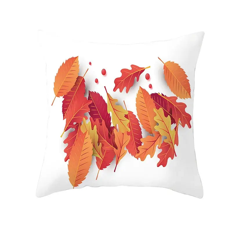 White plush throw pillow featuring vibrant autumn maple leaves design in red orange and yellow for living room decor