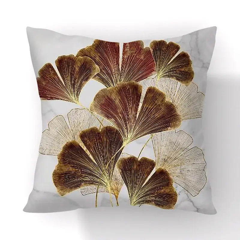 Square cushion cover with elegant golden and brown big leaves pattern on white marble for living room decor