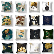Decorative living room cushion covers featuring big leaves botanical prints in gold teal navy and cream colors
