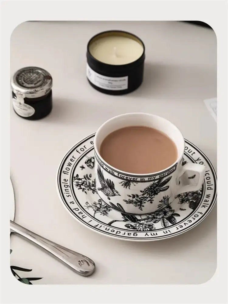 White ceramic teacup with black bird ceramic pattern filled with tea from decorbites black bird coffee set