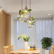 Clear glass pendant light with wooden accents and live green vines from decorbites botanical glass bottle collection