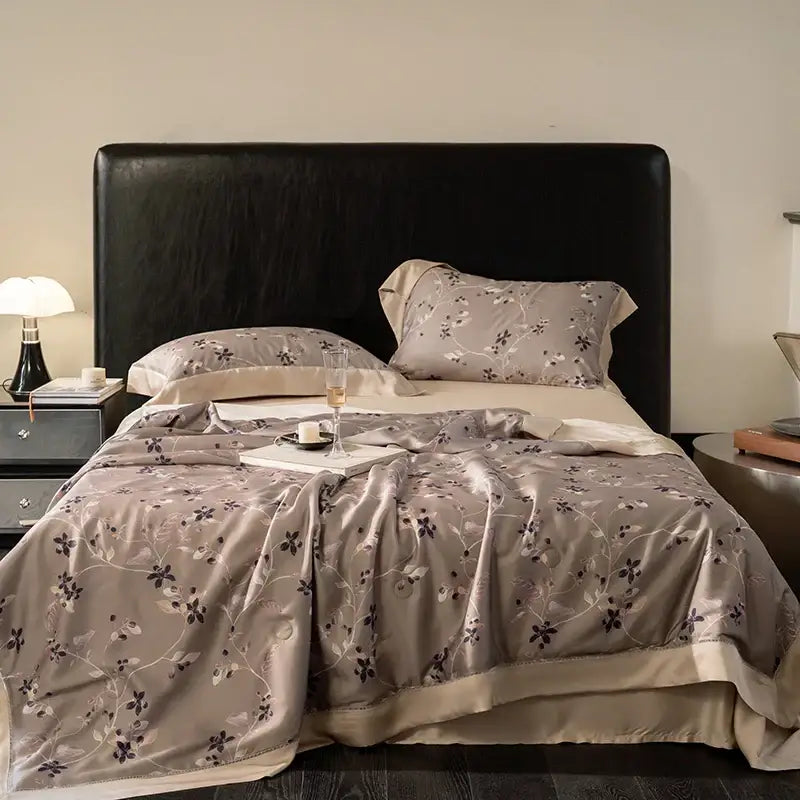 Beige satin quilt set with black and gray floral embroidery made from decorbites eucalyptus fiber flowers for bedroom use