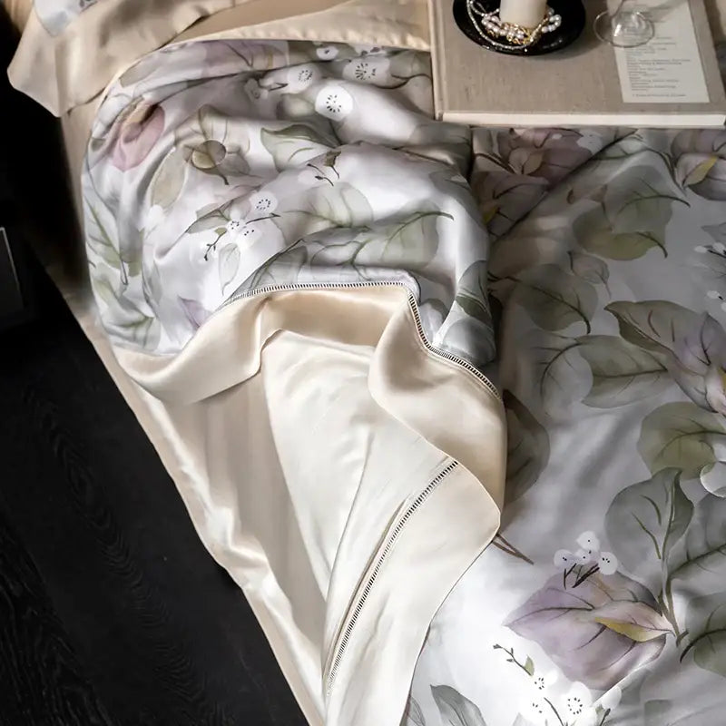 A soft cream-colored satin quilt set with botanical ivory decorbites eucalyptus fiber flowers pattern