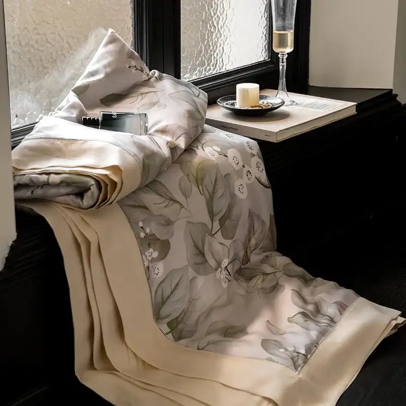 Beige silk throw blanket with delicate gray and white floral embroidery from botanical ivory eucalyptus fiber quilt set