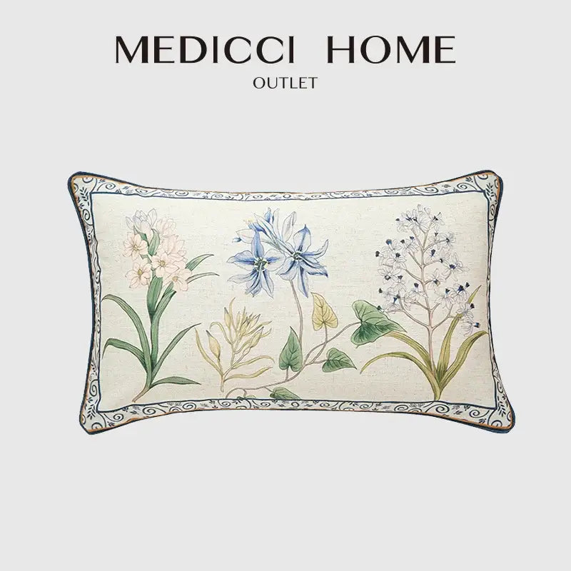 Cream-colored linen lumbar pillowcase with embroidered botanical leaf watercolor design in blue pink and green for bedroom decor