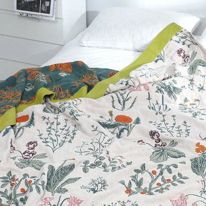 A decorbites cotton leisure two-toned quilt with botanical print in cream and teal and lime-green border cotton leisure blanket