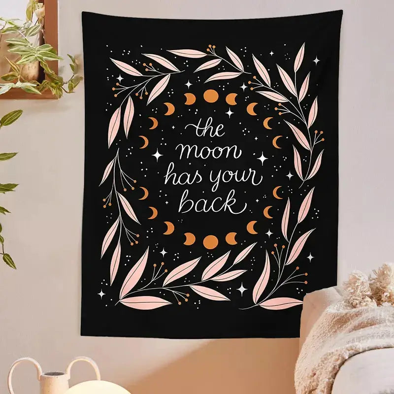Black wall tapestry with botanical olive leaf wreath, orange moon phases, and elegant moon has your back script decorbites botanical olive