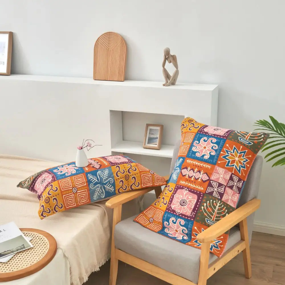 Vibrant patchwork throw pillows with geometric and floral patterns in orange and blue complement cotton gauze blanket bedspread decorbites birds plaid