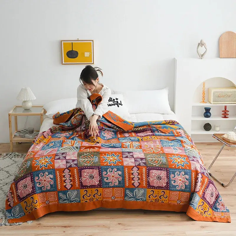 Vibrant botanical orange and blue cotton gauze blanket bedspread with intricate geometric and floral patterns for bedroom decorbites birds plaid