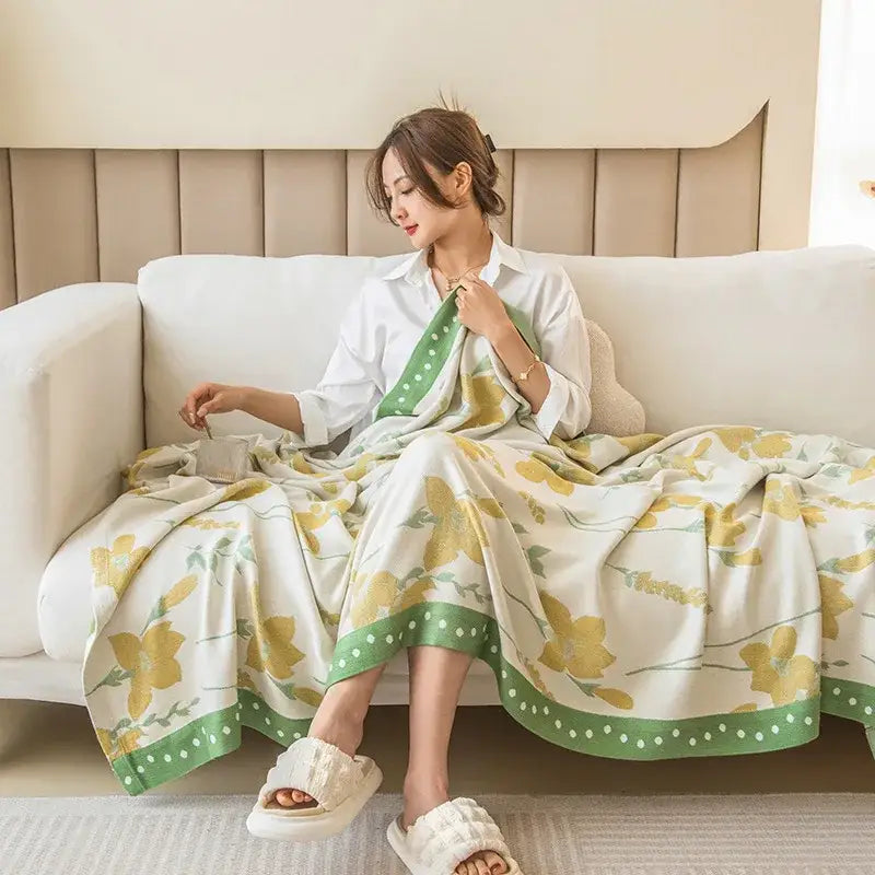 A soft white robe with yellow floral pattern and green polka dot trim complementing the decorbites bamboo four layer summer quilt