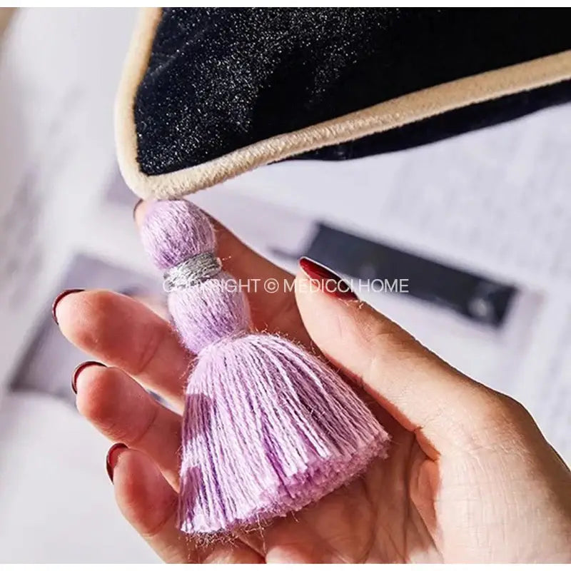A delicate lavender tassel with silver band on botanical wisteria embroidered black velvet cushion cover decorbites