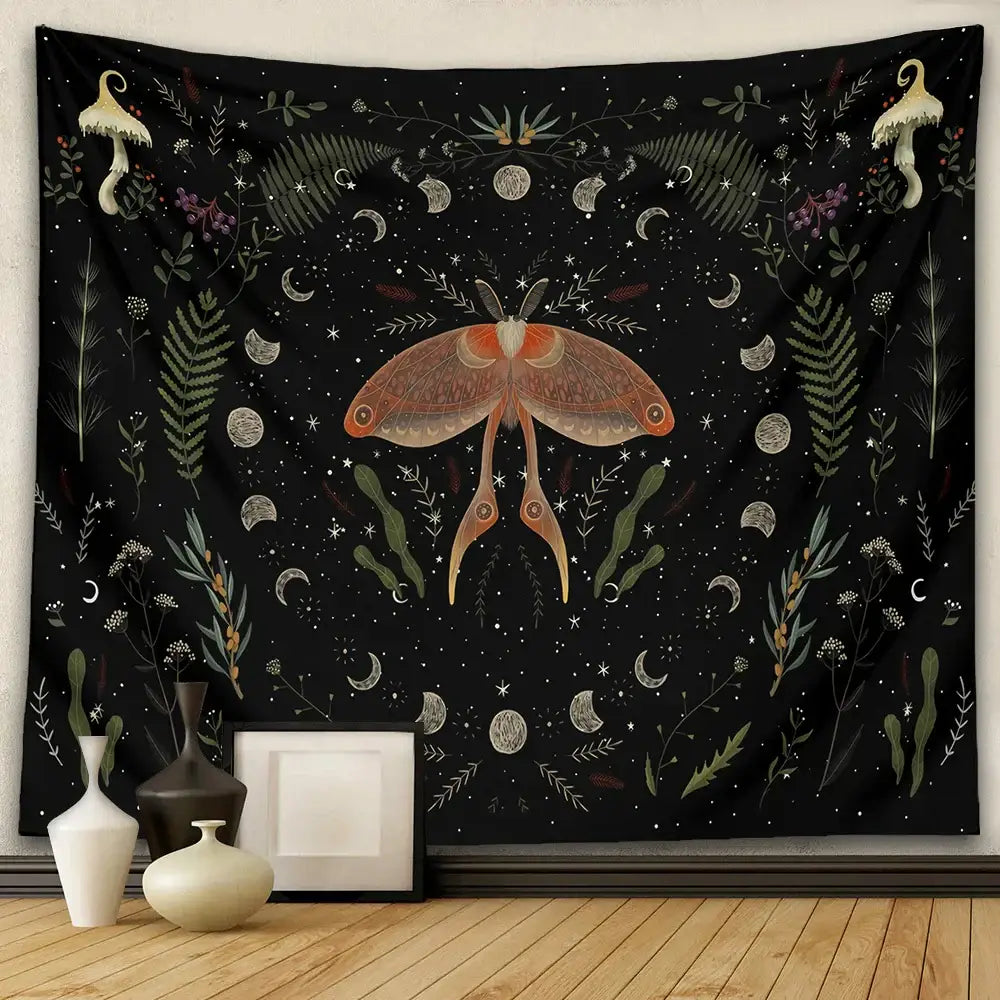 Black botanical witchy tapestry featuring an orange moth with green foliage white moons stars and cream mushrooms wall decor