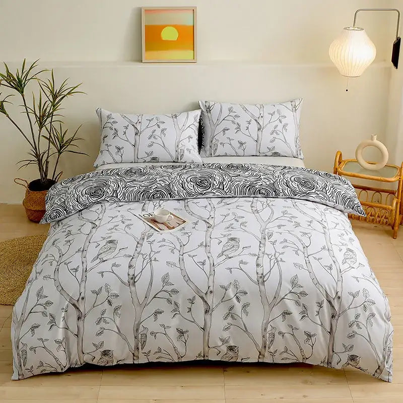 White duvet cover set featuring black ink-style tree and bird illustrations in botanical yellow and white floral design