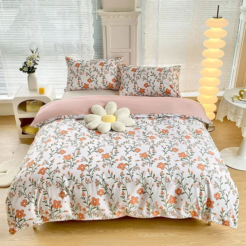 Soft white duvet cover set with delicate orange and green floral pattern and pink inner lining for bedroom bedding