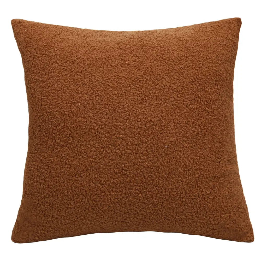 A rust-colored boucle teddy throw pillow with plush textured faux fur surface for cozy living room decorbites boucle teddy set