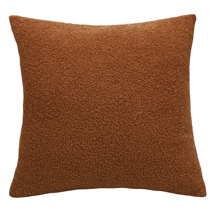 A rust-colored boucle teddy throw pillow with plush textured faux fur surface for cozy living room decorbites boucle teddy set