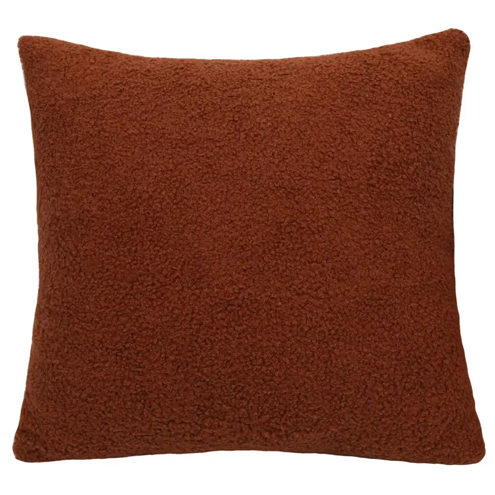 A rust-colored boucle teddy throw pillow with a plush textured faux fur surface from the decorbites living room set