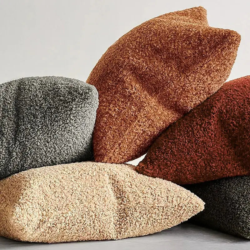 A cozy boucle teddy throw pillow in warm terracotta with a plush fuzzy surface for living room decorbites decor