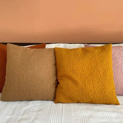 Warm-toned boucle teddy throw pillows in mustard yellow and caramel brown for cozy living room decorbites boucle teddy set