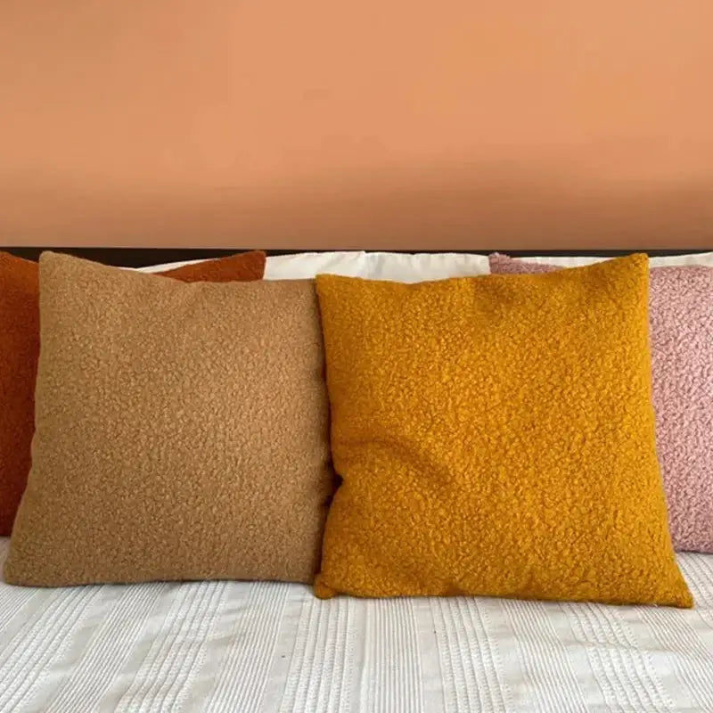 Warm-toned boucle teddy throw pillows in mustard yellow and caramel brown for cozy living room decorbites boucle teddy set