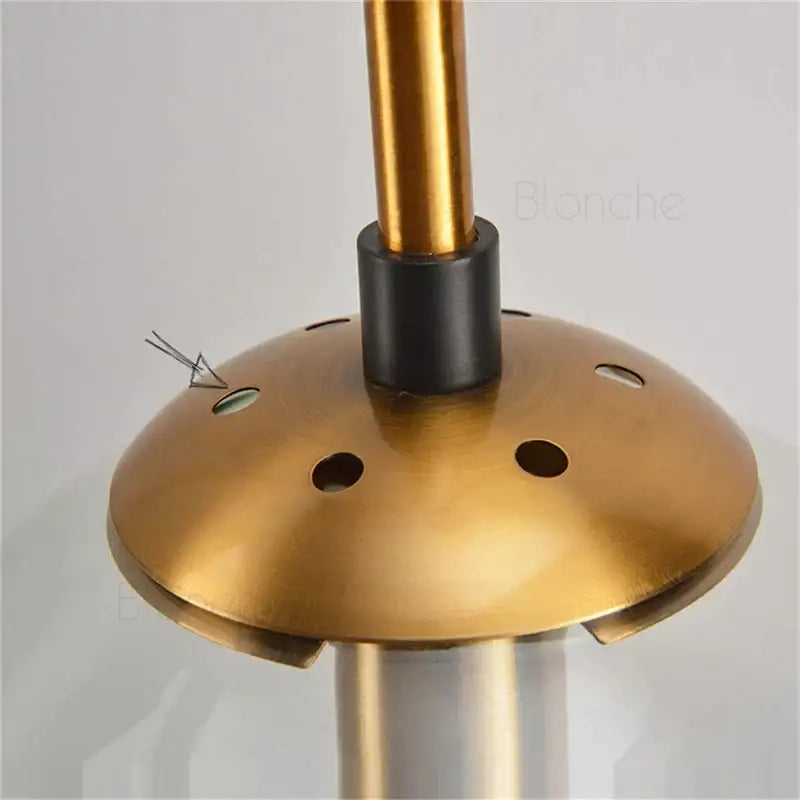 Gold-colored brass base with circular design and black central collar for decorbites glass ball wall light for living room