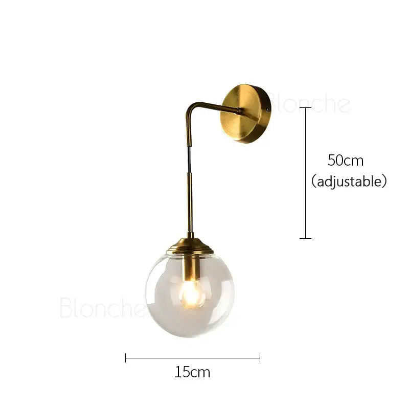 A brass amber glass ball wall light with a sleek brass finish and spherical glass globe for bedroom and living room decorbites glass ball