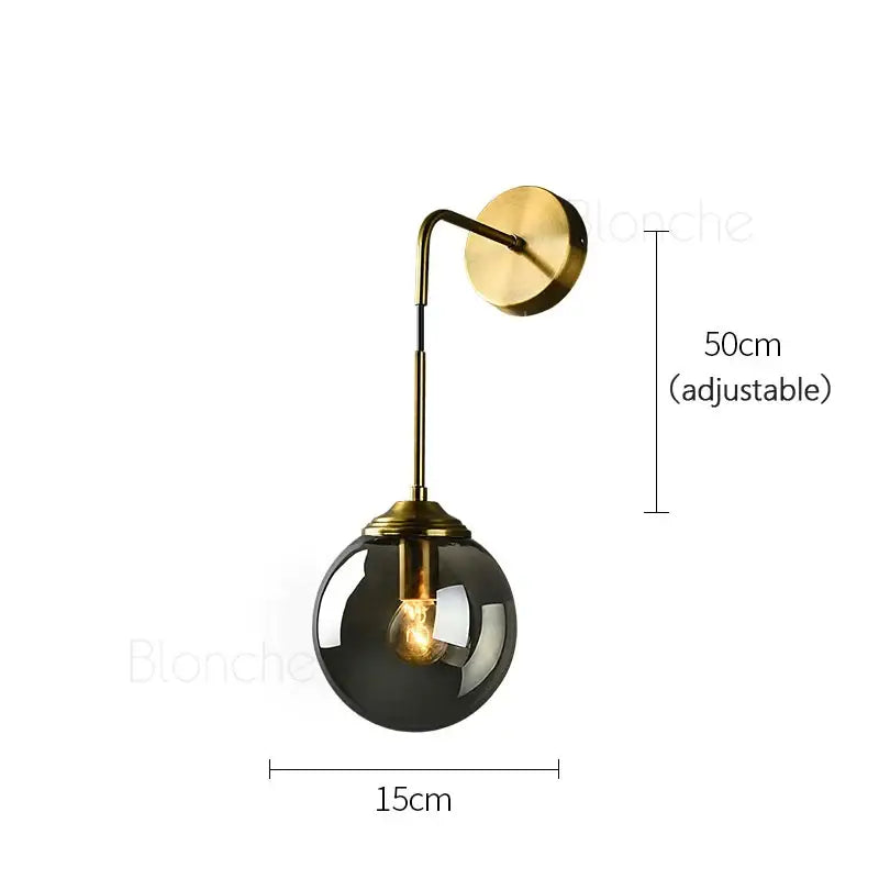 A brass amber glass ball wall light with polished brass arm and smoked glass globe for bedroom and living room decorbites glass ball