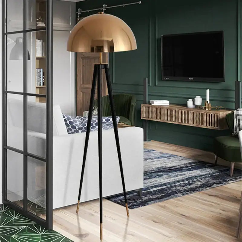 A sleek brass and black coyote gold tripod floor lamp with polished finish ideal for living room decorbites coyote gold