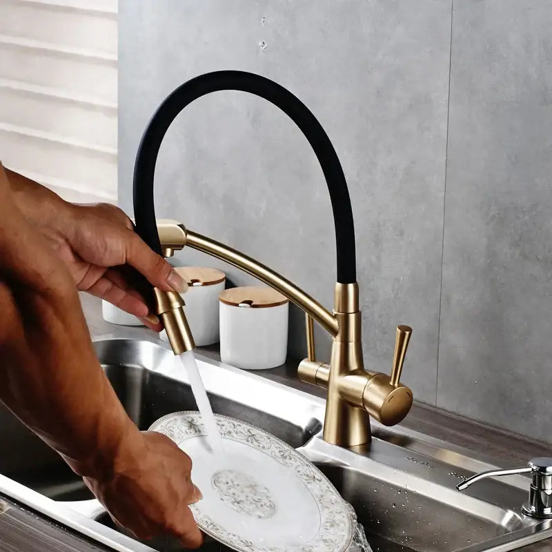 Gold-toned brass and black decorbites dual spout kitchen faucet with flexible hose and three dual handles for kitchen use