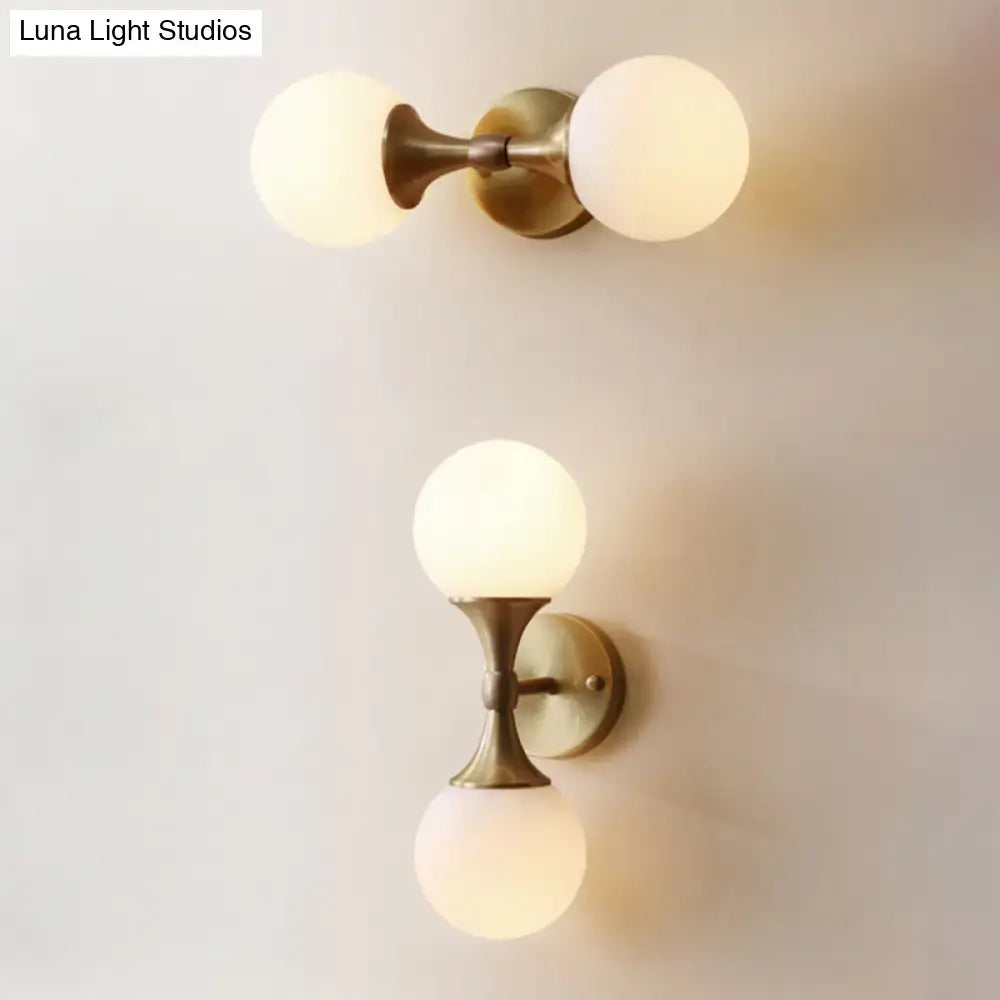 Decorbites™ ivory glass ball wall lamp with two frosted glass globe shades and brass-finished two-head wall lamp