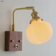 Brass and walnut ceramic led wall light with ribbed frosted glass globe and dark wood mounting plate for bedroom decorbites ceramic led wall