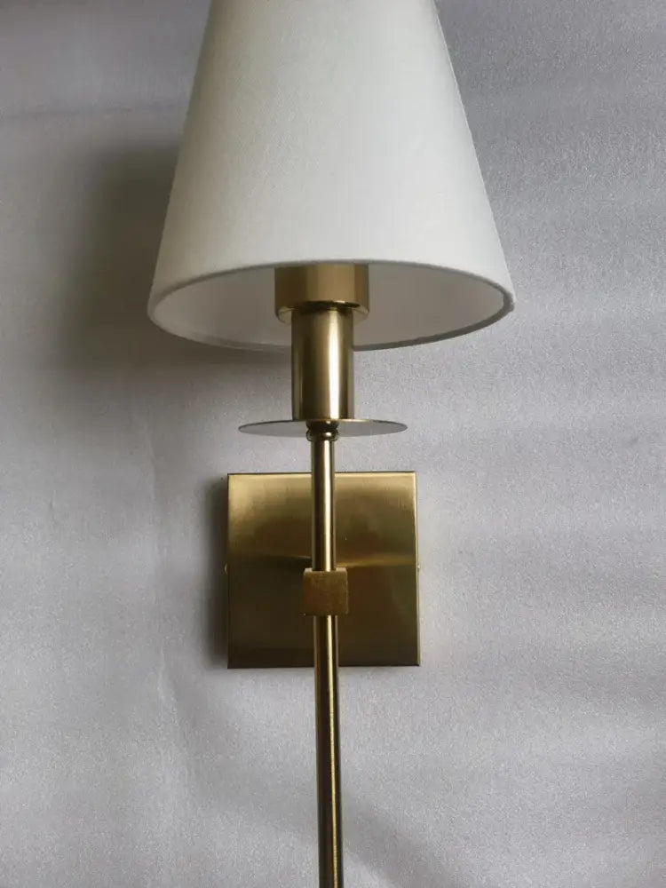 A sleek brass wall sconce with a white cloth lampshade ideal for bathroom mirror decorbites cloth lampshade wall