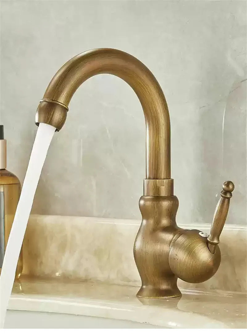 Brass antique bathroom sink faucet with antique brass finish curved spout and ornate handle for kitchen use