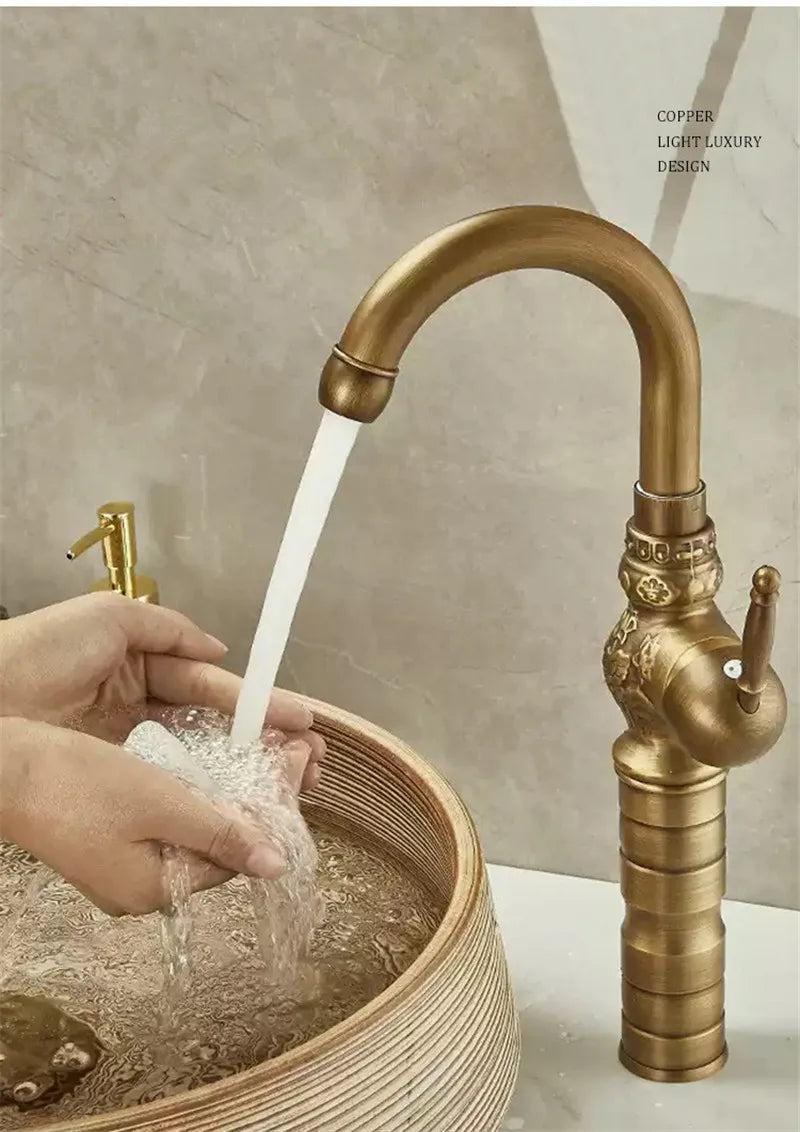 Brass antique bathroom sink faucet with brass-finished copper material, ornate detailing, and curved spout design