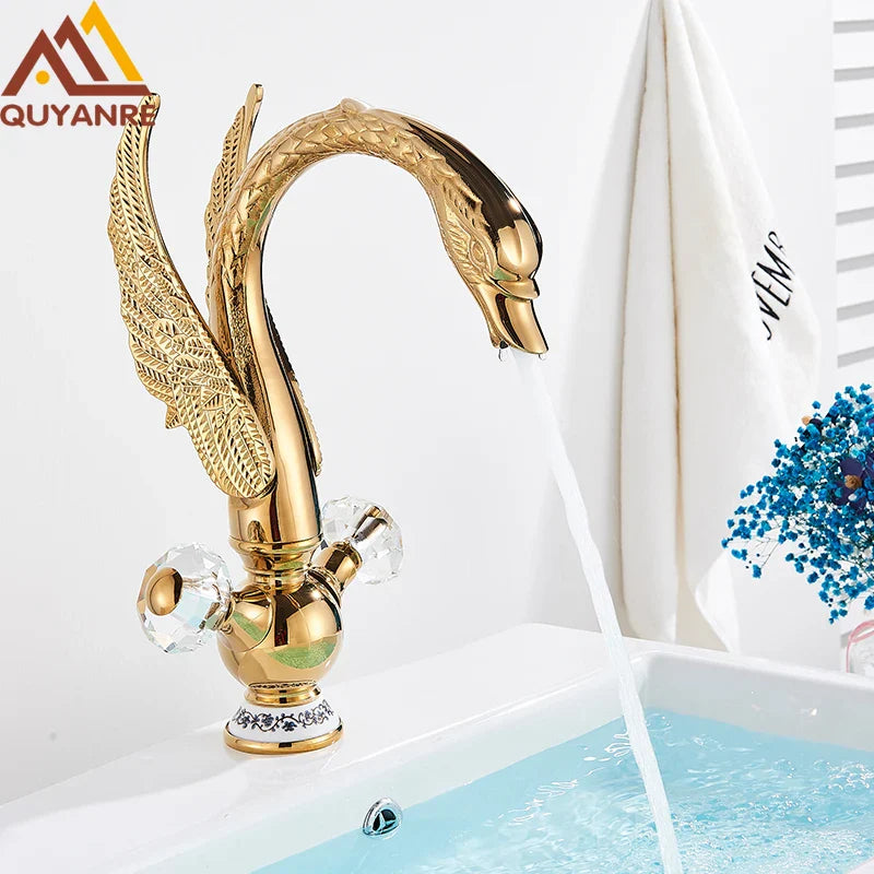 Brass basin faucet deck mounted in antique brass with golden swan shape and crystal knob detailing