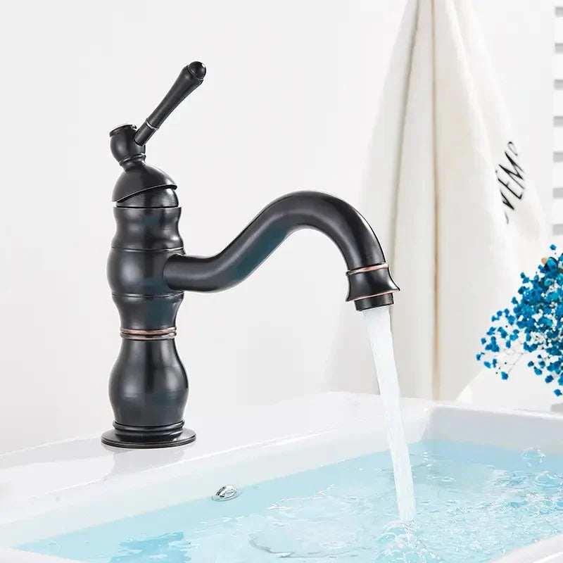 Black matte finished brass bathroom basin mixer faucet with curved spout and ornate segmented body