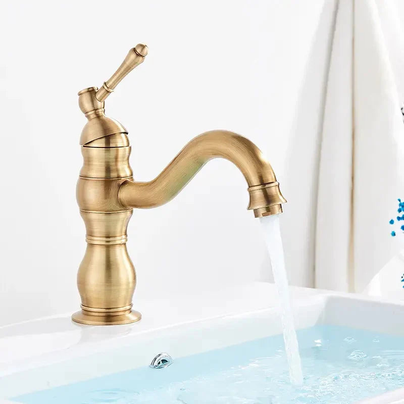 Antique brass finish single-handle bathroom basin mixer faucet with curved spout and decorative ridged body