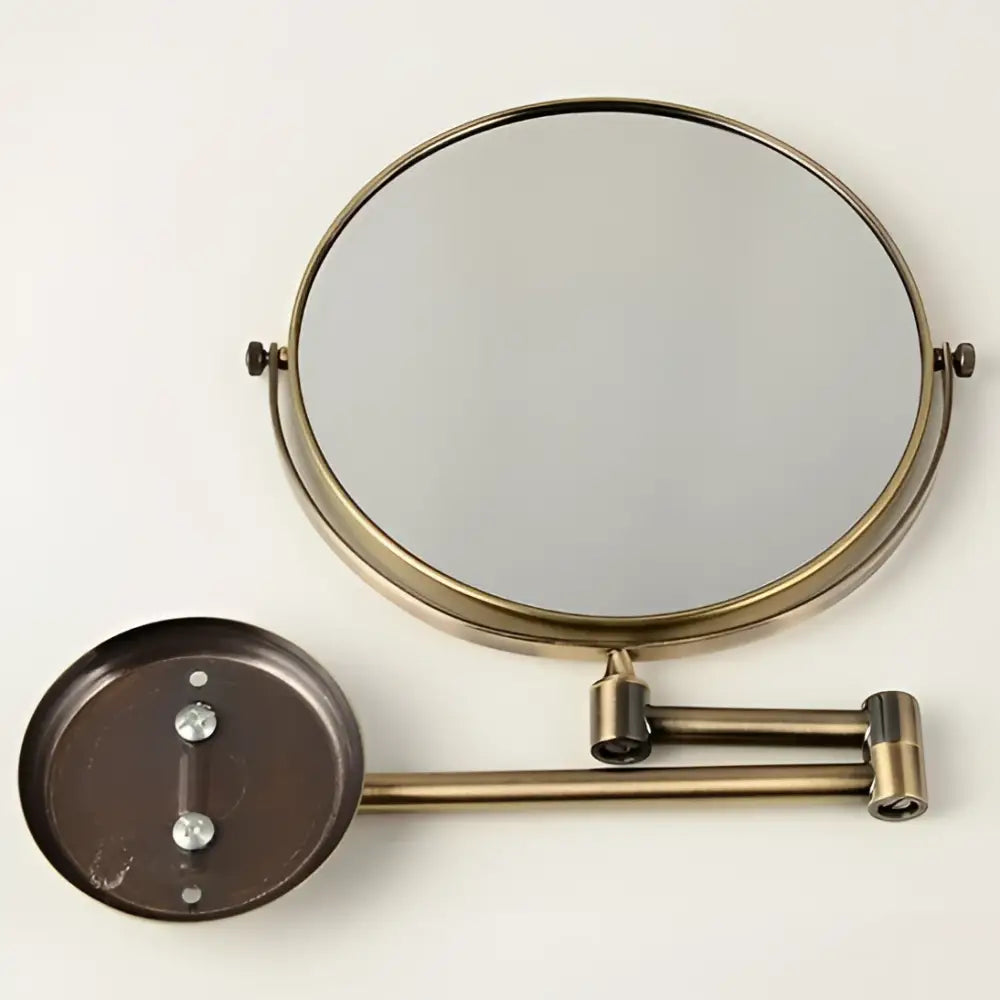 Brass bronze folding makeup mirror with circular magnifying glass and adjustable wall-mounted articulated arm by decorbites brass bronze