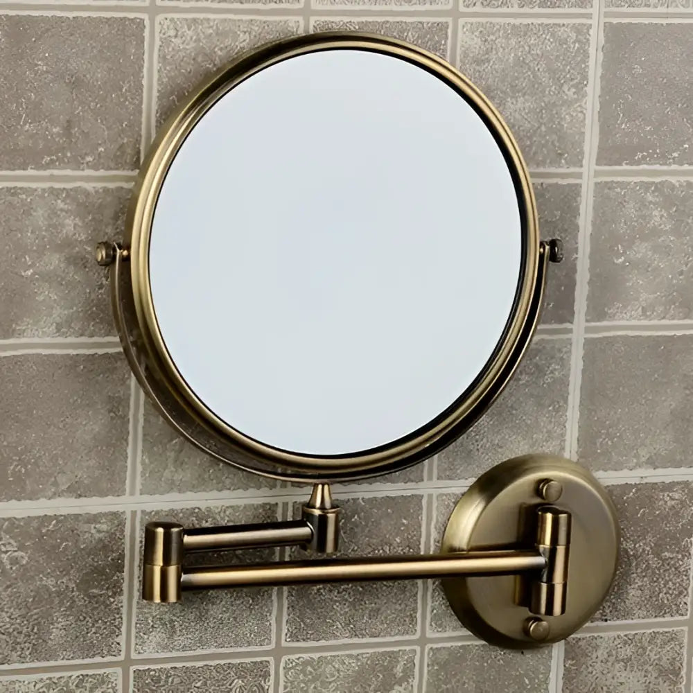 Brass bronze folding makeup mirror with brass-finished circular frame and adjustable wall-mounted articulated arm
