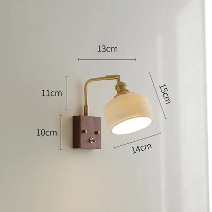A brass ceramic ball led wall light with a yellow globe and off-white ceramic shade for living room wall lighting