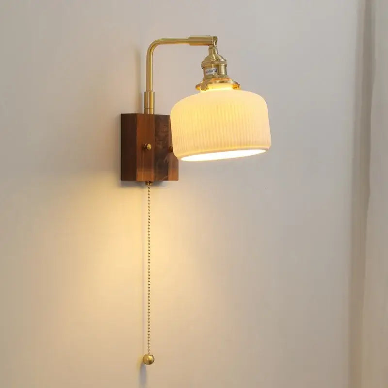 Brass ceramic ball led wall light with yellow globe and ribbed off-white glass shade on wooden base for living room wall light