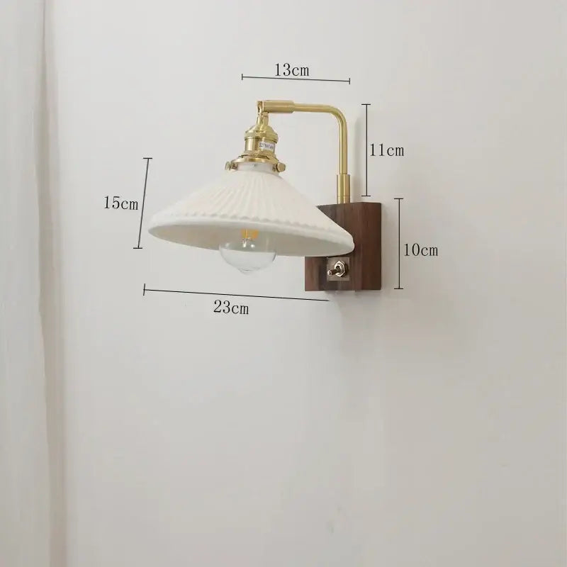 Vintage-style brass ceramic ball led wall light with white fluted glass shade and dark wood base for living room