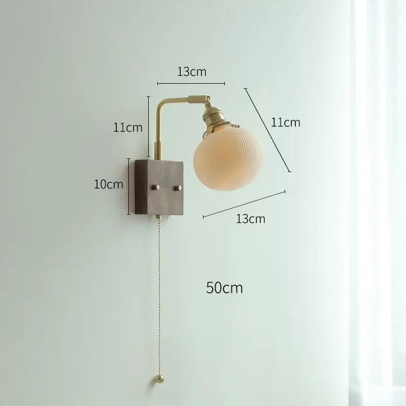 Vintage-style brass led wall light with frosted yellow globe and adjustable arm for living room lighting